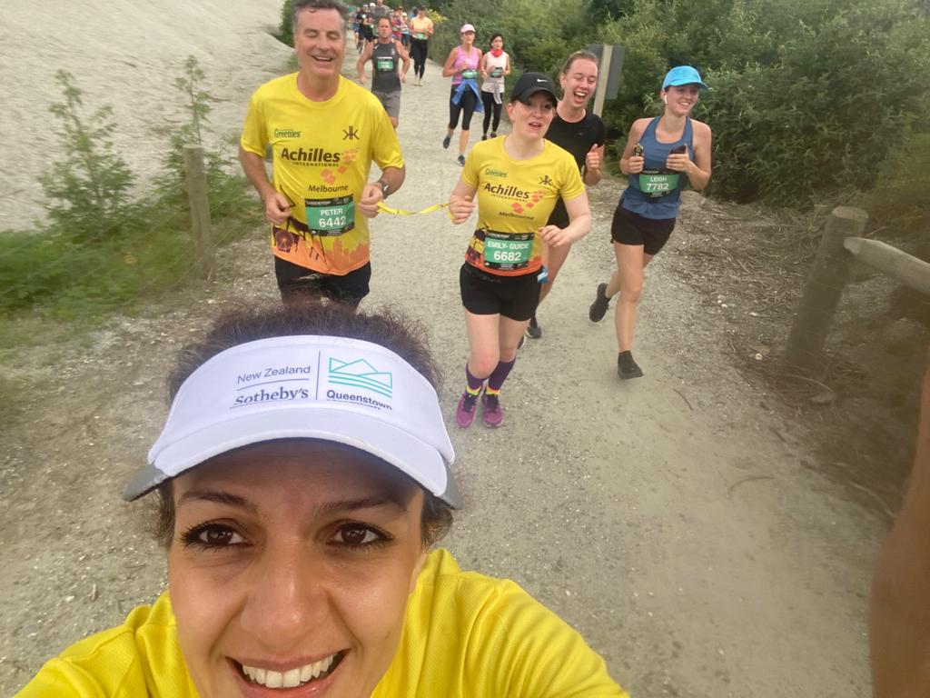 A running selfie, view of Leila taking the selfie. Leila in Achilles yellow and white visor that says 