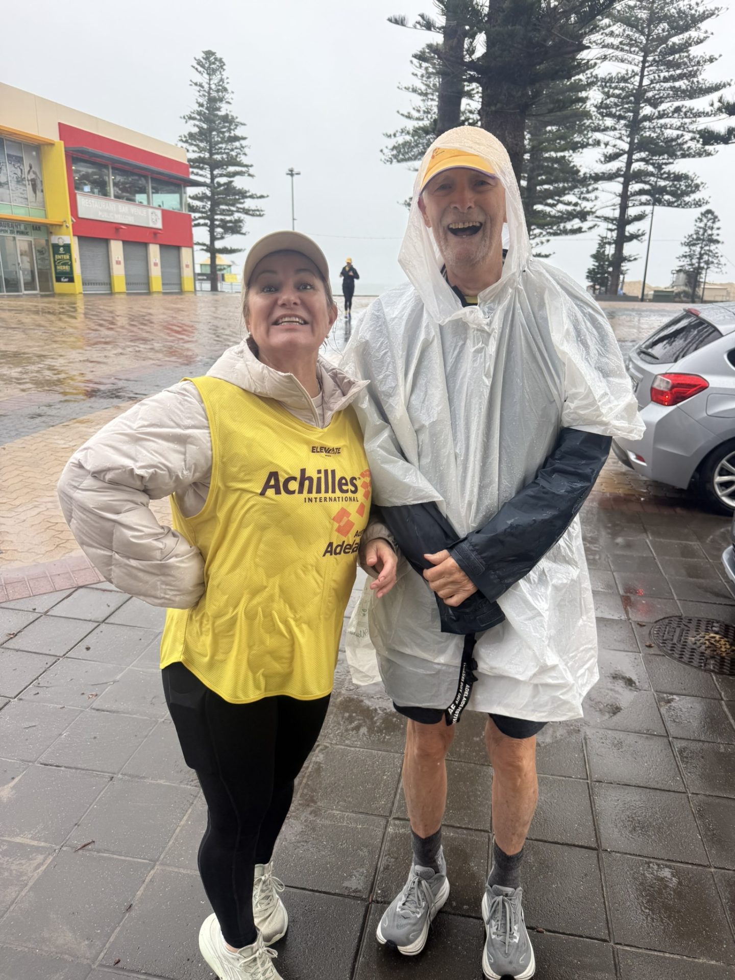 Kirrily and Tony in the wind and rain at Glenelg