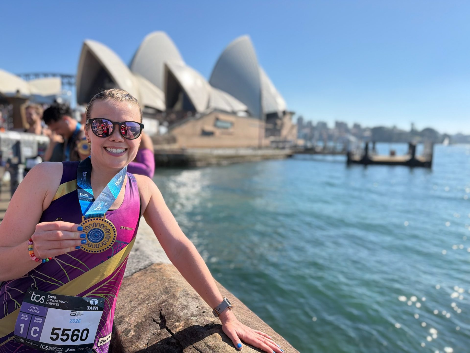 Anna Pearce after marathon with opera house behind